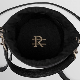women wearing black leather crossbody bag