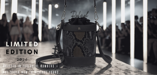 Black handbag with snake skin pattern on a runway with 'Delval' branding.